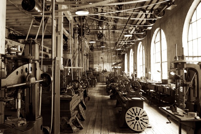 Heavy machine shop, with machines in rows across the room.