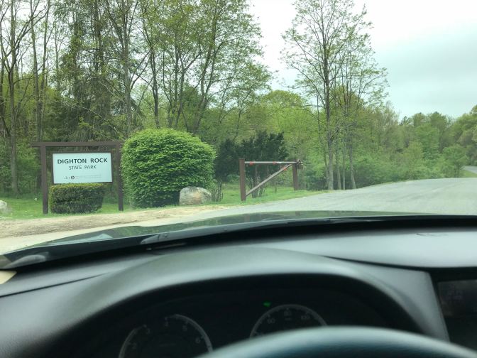 View of entrance to Dighton Rock State Park, from behind a car's dashboard.