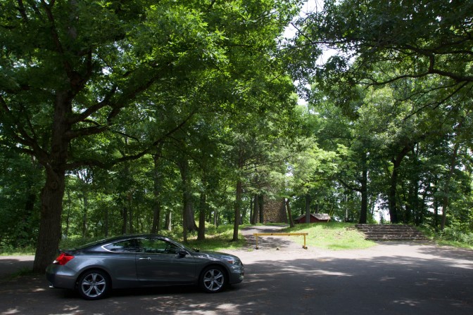 2012 Honda Accord in parking lot. The base of the tower is visible in the background.