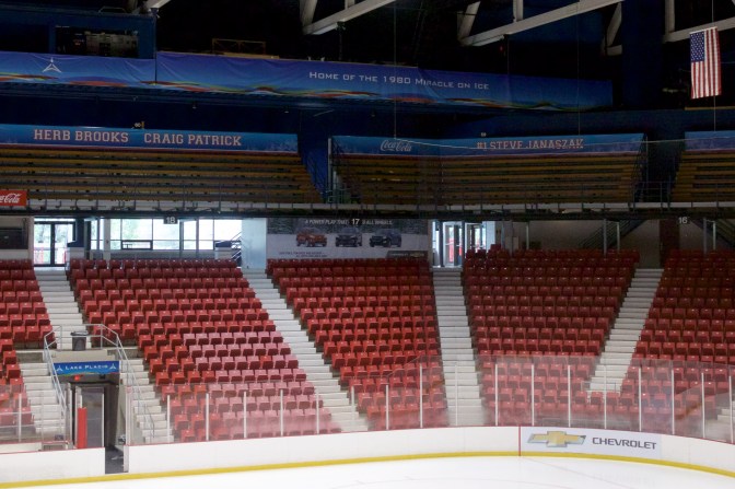 View of the right corner of the arena. A ring of honor - blue banners with white letters, list the names of the team. Visible on the signs in this photo are Herb Brooks, Craig Patrick, Steve Janaszak, and 