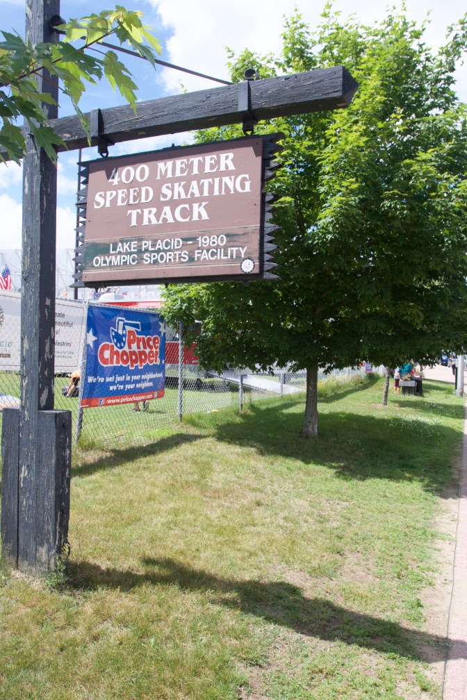 Sign on a wooden signpost that states 400 METER SPEED SKATING TRACK Lake Placid 1980 Olympic Sports Facility