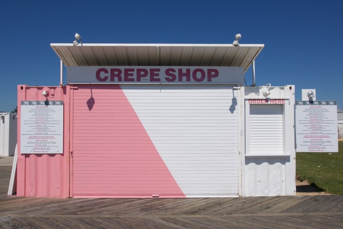 View of a Crepe shop, painted half pink and half white.