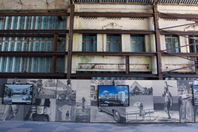 Interior of the casino, with scaffolding supporting the walls. Photos in the foreground show coming redevelopment to the casino district.