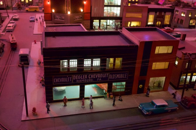 Miniature car dealership. Building sign says DEGLER CHEVROLET HAMBURG PA.