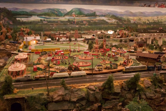 View of railroad tracks surrounding a small circus.