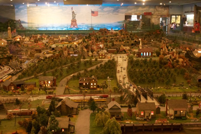Overview of diorama. A large statue of liberty and American flag are on the far wall.