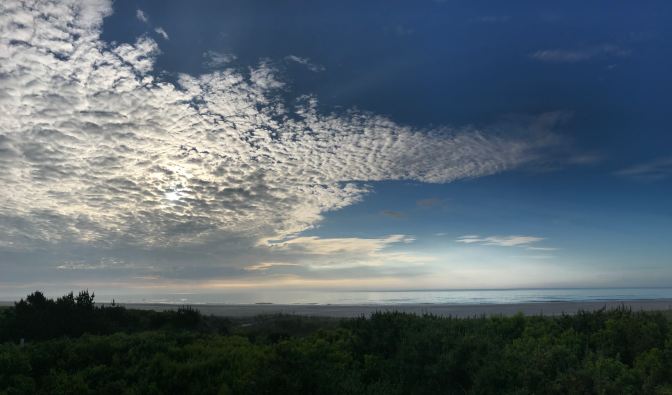 View of the ocean from the New Jersey coast. The sky is a mixture of blue and clouds.