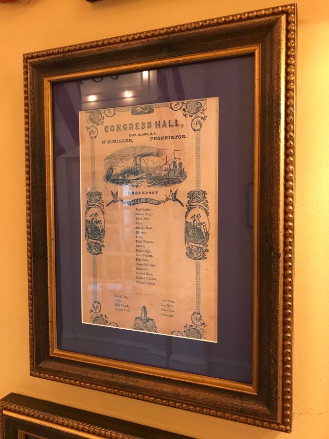19th century breakfast menu, framed and displayed in a hotel corridor.