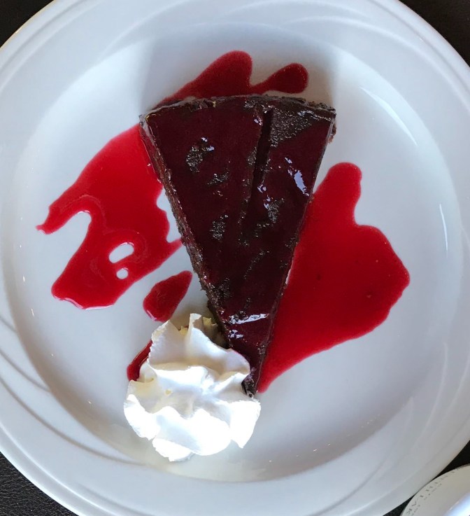 Chocolate Gataeu with ice cream, on a white plate.