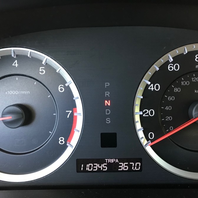 Car odometer that reads 110345 miles.