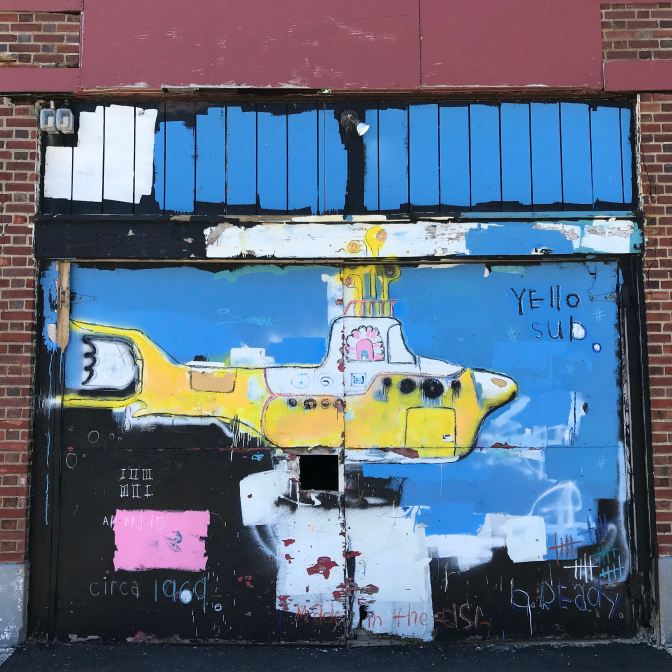Mural of a Yellow Submarine. Words on the wall read YELLO SUB CIRCA 1969.
