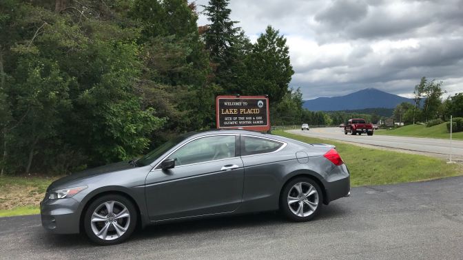 2012 Honda Accord in front of sign that says WELCOME TO LAKE PLACID - Site of the 1932 and 1980 Olympic Winter Games.
