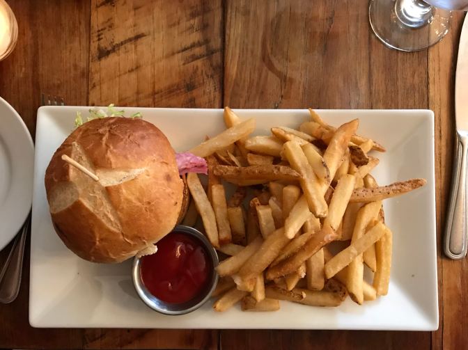 Salmon burger with fries.