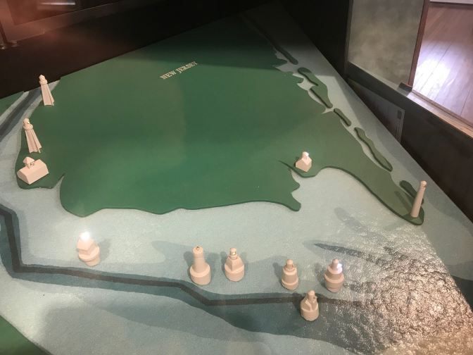 3D map of New Jersey, with small models of lighthouses.