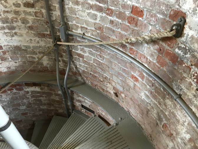 Rope railing beside the stairs of the lighthouse.