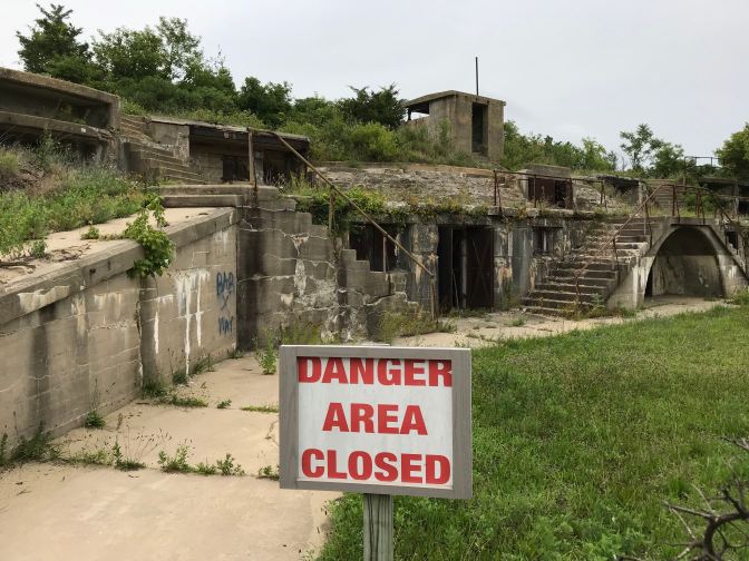 Remains of Nine Gun Battery. A red sign in the foreground says DANGER AREA CLOSED.