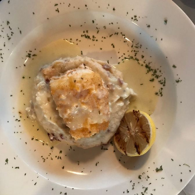 Chilean sea bass with lemon barre blanc on a plate.