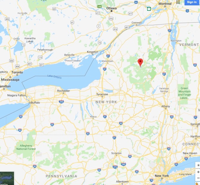 Map of New York State, with a pin in the location of Raquette Lake.
