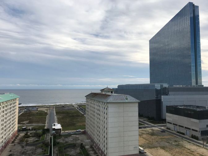 View of the Atlantic Ocean from the top of the lighthouse. Several apartment buildings and a casino are in the foreground.