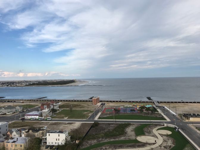 View of Atlantic Ocean, with houses and empty plots of ground in the foreground.