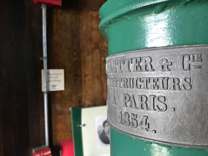 Metal plaque on cupola of lighthouse that indicates construction in Paris in 1854.