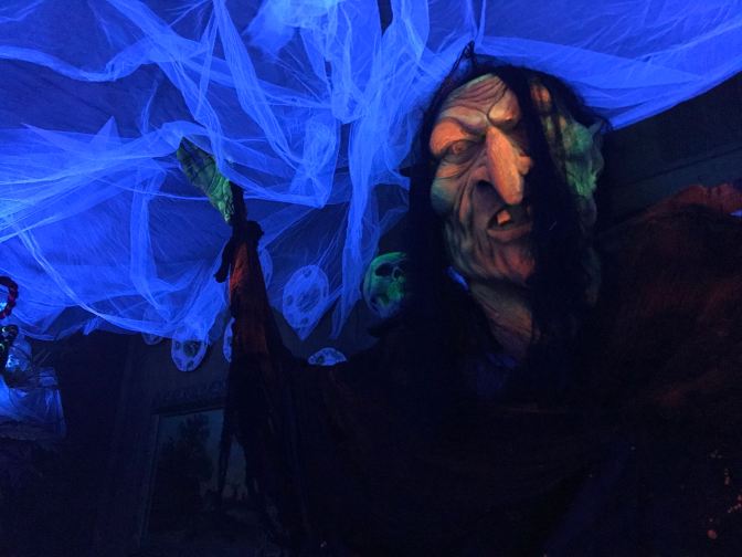 Troll affixed to the wall above a table.