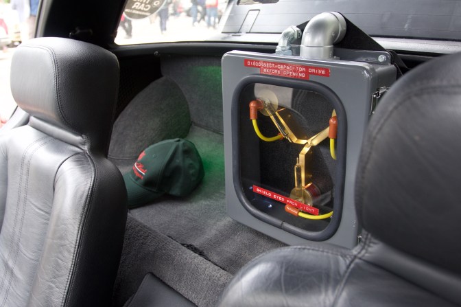 View of DeLorean interior, with capacitor drive from Back to the Future behind the seats.