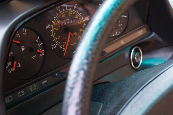 Car instrument panel with odometer reading 203512 miles.