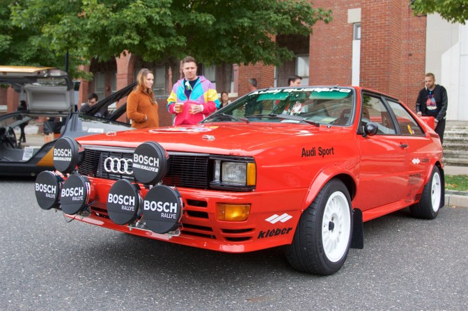 Red Audi Quattro with rally lights on the front.