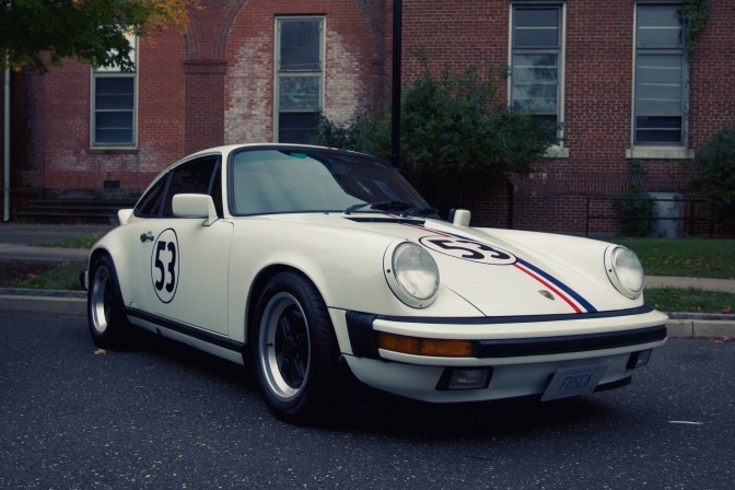 Porsche 911 in white, with the number 53 on the door and hood.