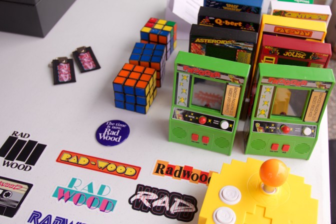 Souvenir stand including Rad-Wood stickers, Rubik's cubes, and miniature video games.