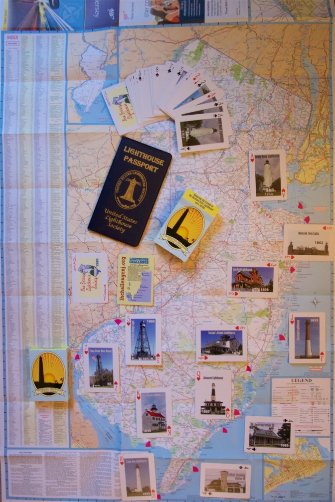 Map of New Jersey with cards arranged at the relevant lighthouses and a Lighthouse Passport book on it as well.
