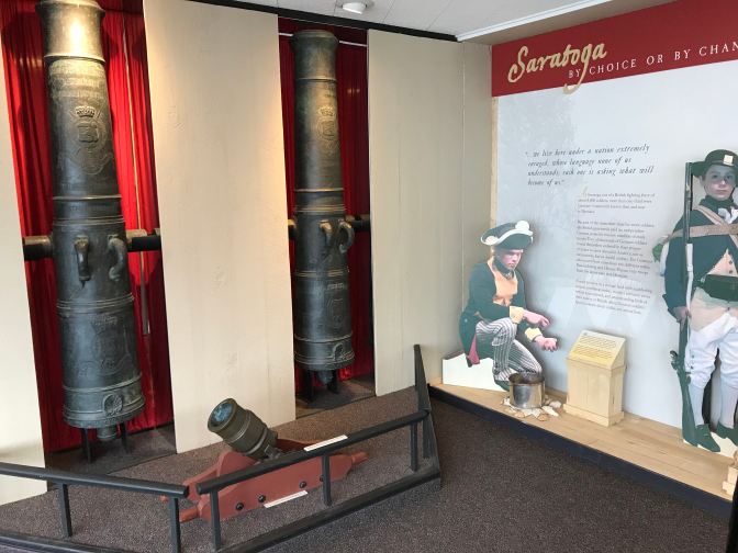 Two British cannons, recessed into the wall, alongside a display of the battle.