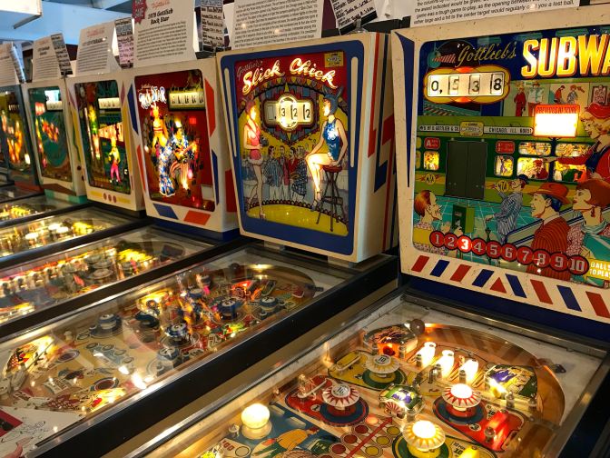 Row of classic pinball machines including SUBWAY and SLICK CHICK.