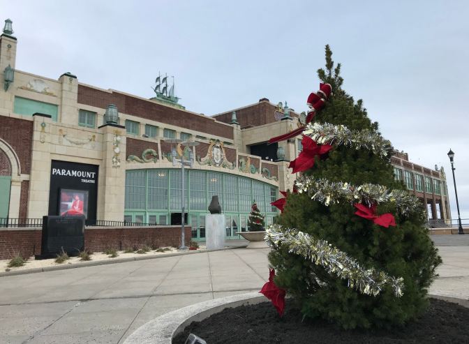 Small Christmas tree, decorated with silver tinsel, in front of Convention Hall.