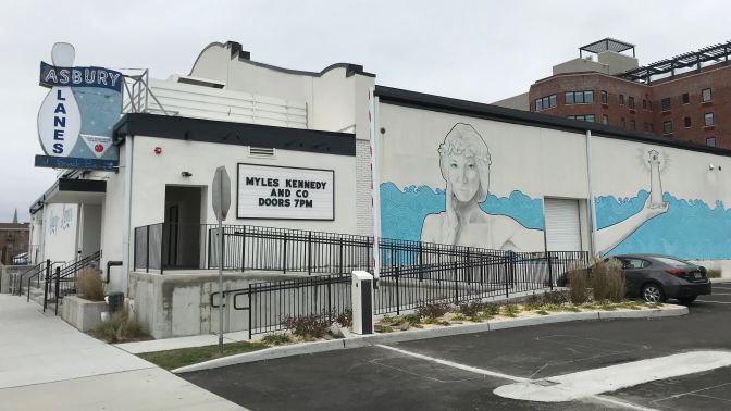 Exterior of Asbury Lanes. A sign says MYLES KENNEDY AND CO DOORS 7PM