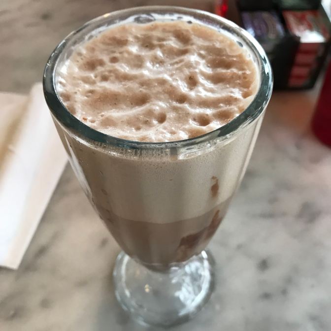Chocolate egg creme soda in a glass.