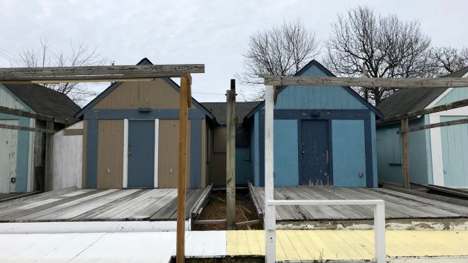 Frontal view of wooden sheds.
