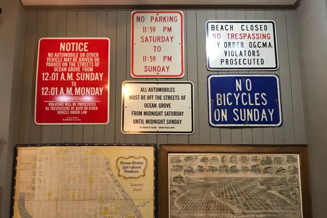 Signs declaring that beaches are closed and driving is forbidden during Sundays.