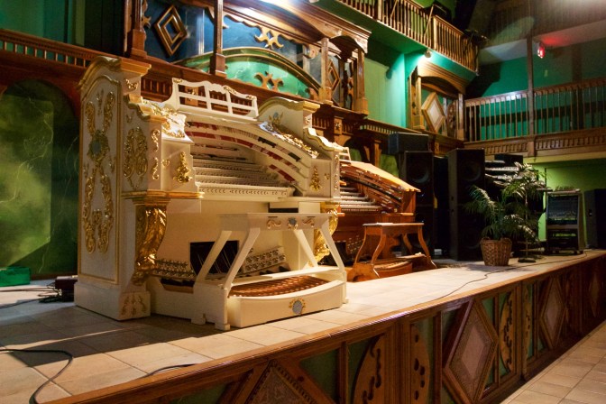 Pipe organ keyboards on stage.