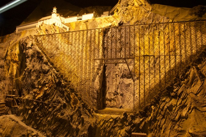 Large trestle bridge on a mountainside over a crevasse.