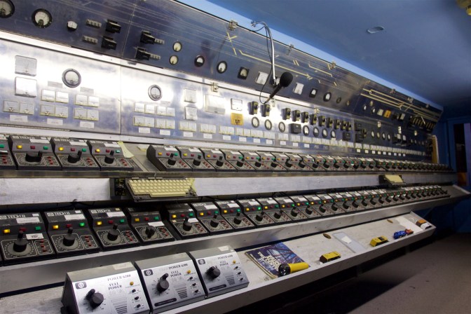 Switchboard controlling trains, which fills a 30-foot long wall in a  room.