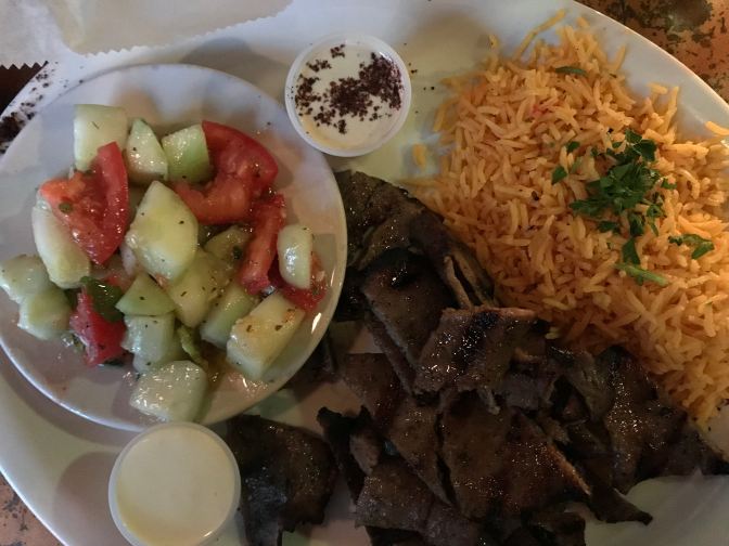 Beef and lamb gyro with basmati rice and cucumber and tomato salad.