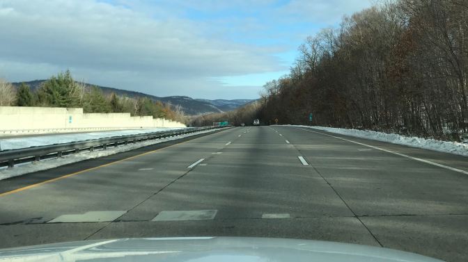 Highway from behind dashboard of 2014 Jeep Grand Cherokee. Catskill Mountains are in the background.