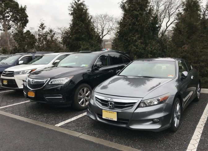 2012 Honda Accord parked in a row with other vehicles, including a black Acura MDX directly next to the car.