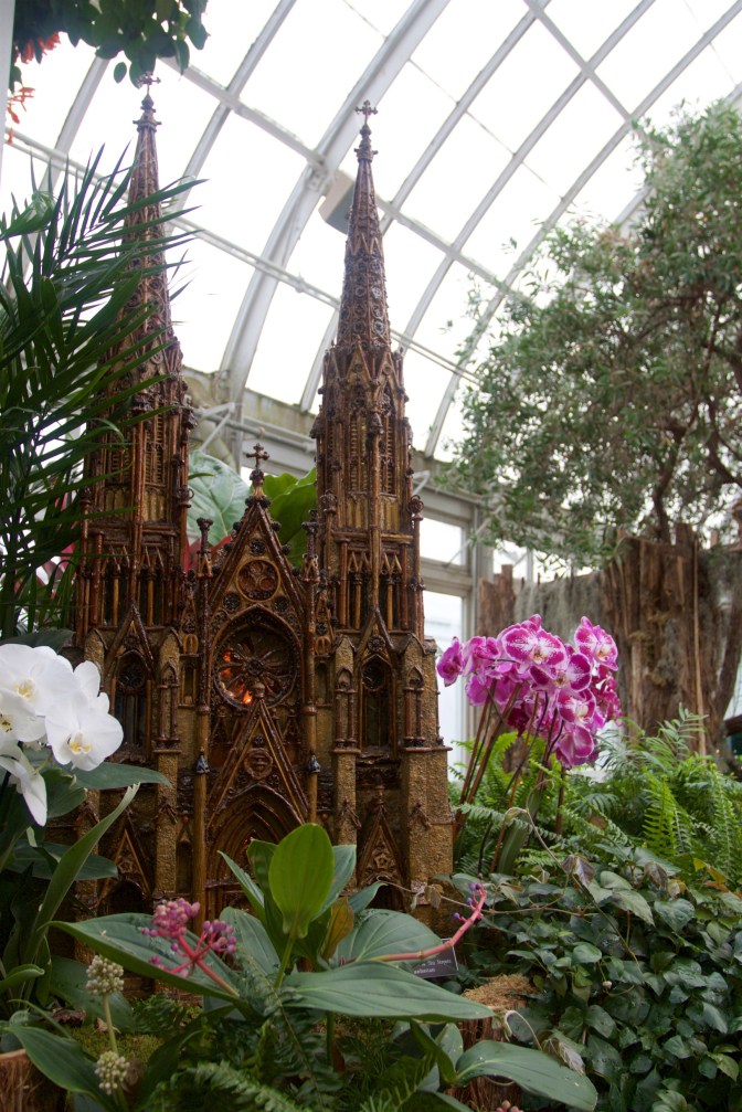 Model of St. Paul's Cathedral, surrounded by orchids.
