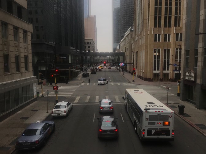 View of skyways from inside a skyway. Buses and cars are in the streets below.