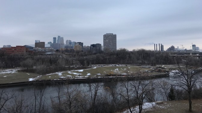 View of the skyline of Minneapolis, with the Mississippi River in the background.