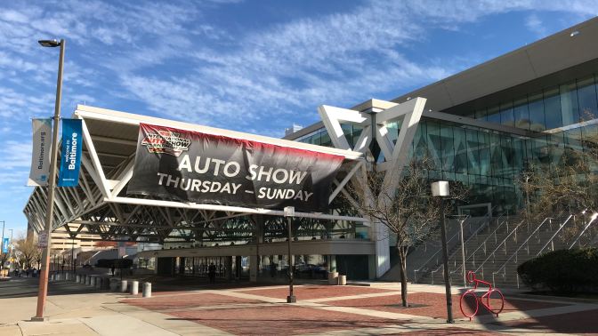 Exterior of Baltimore Convention Center, with a banner hanging that says AUTO SHOW THURSDAY - SUNDAY