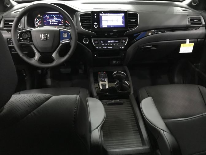 Interior of Passport, with view of front seats and dashboard.